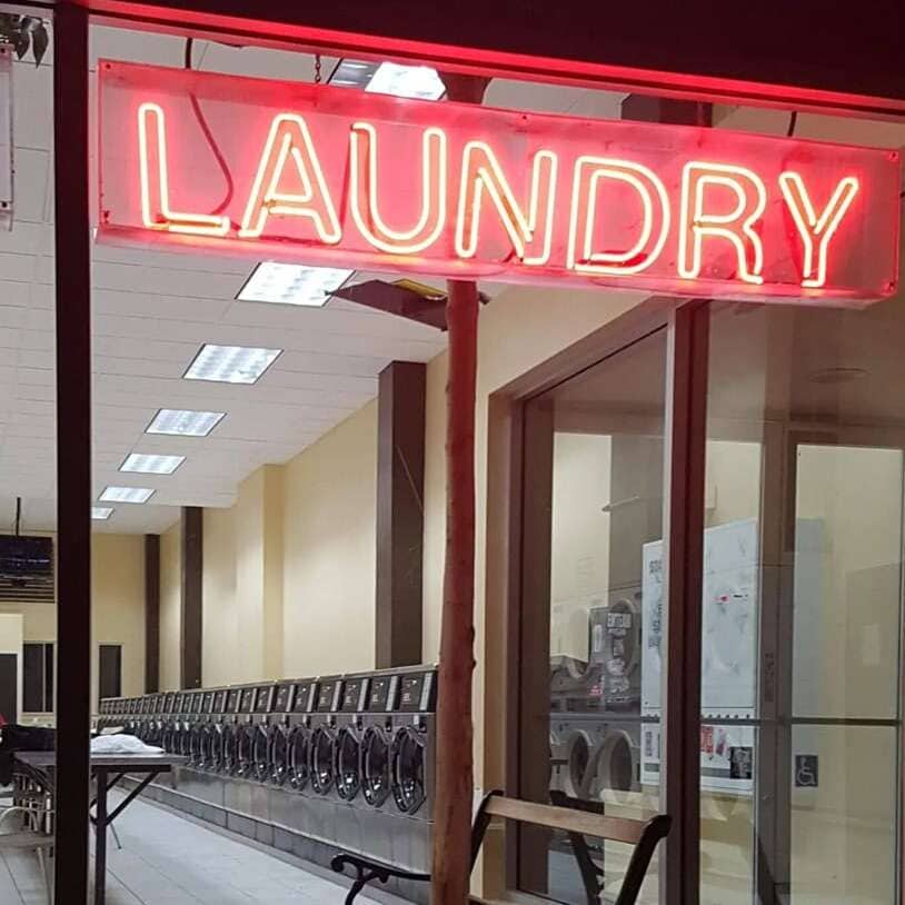 Red laundromat real glass neon sign with bold Laundry lettering