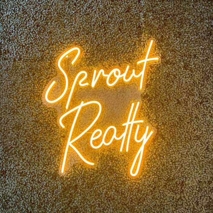 Warm yellow custom neon sign for a realty office