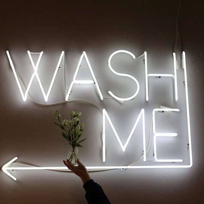 White laundromat real glass neon sign with a directional arrow