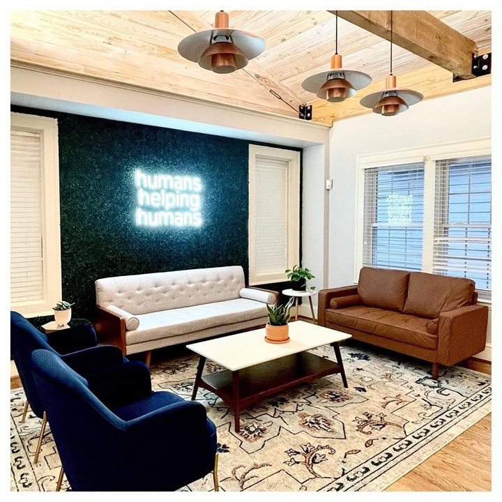 White neon slogan sign for a real estate office lounge