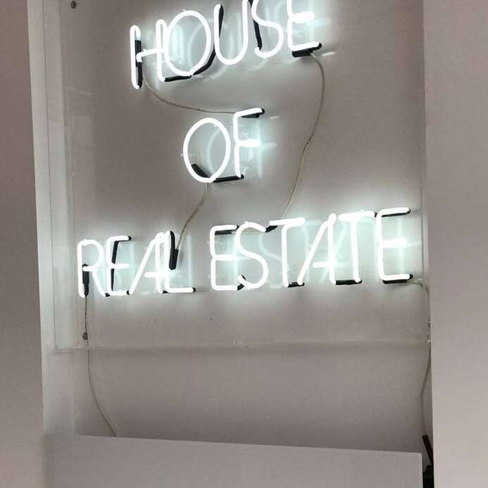 White real estate office neon sign with modern block lettering