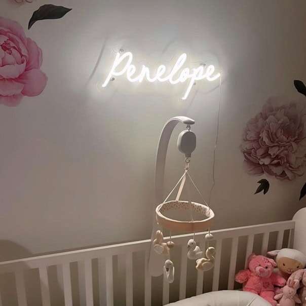 White script nursery neon sign with a personalized name