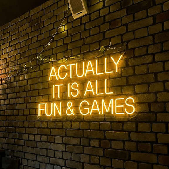 Yellow Fun and Games neon sign for a basement rec room
