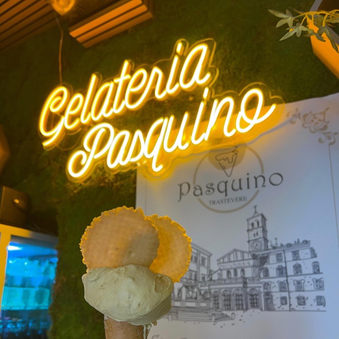 Yellow Gelateria Pasquino neon sign with a gelato cone