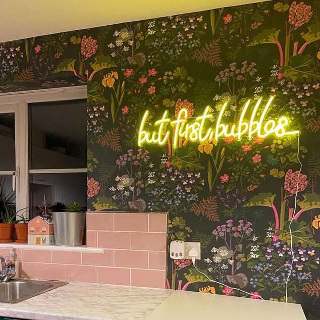 Yellow script neon sign for a kitchen with floral wallpaper